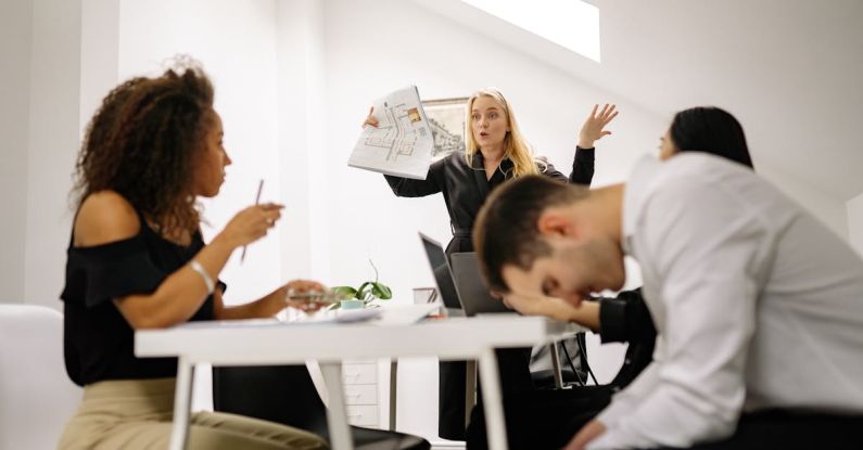 Workplace Conflict - A Woman Standing in Front of the Group