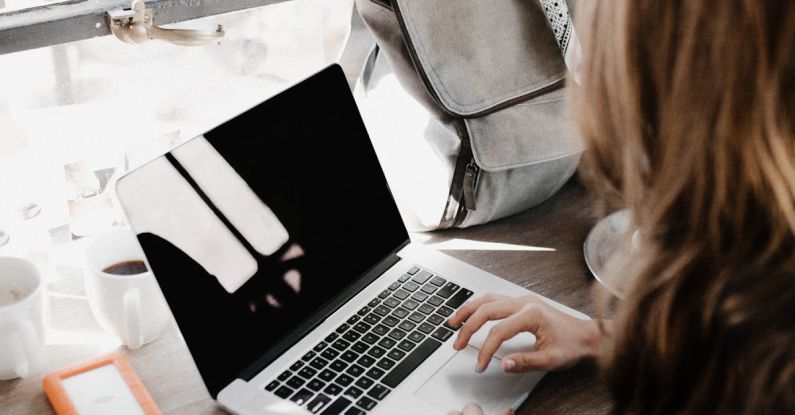 Side Hustle - Close-up Photography of Woman Sitting Beside Table While Using Macbook